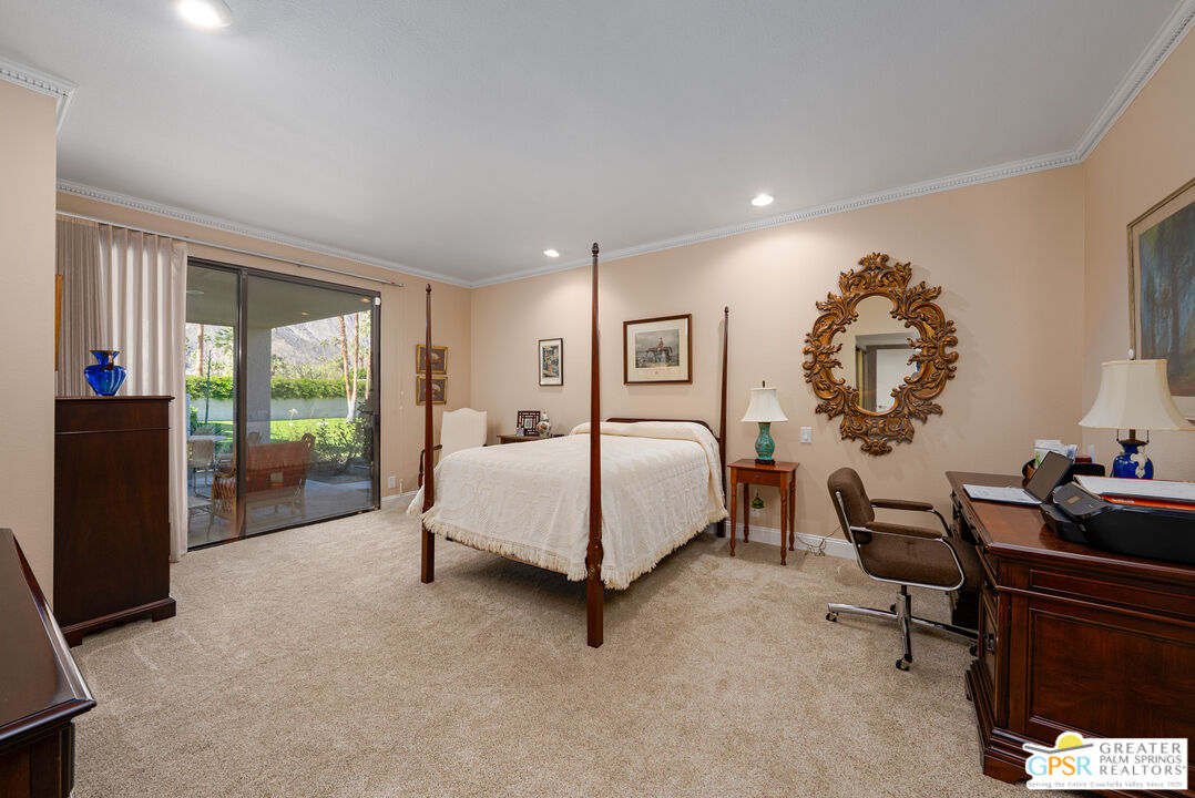 1142 East La Jolla Road Palm Springs, CA 92264 - Photo 15 of 35 a spacious bedroom with a large bed and a window
