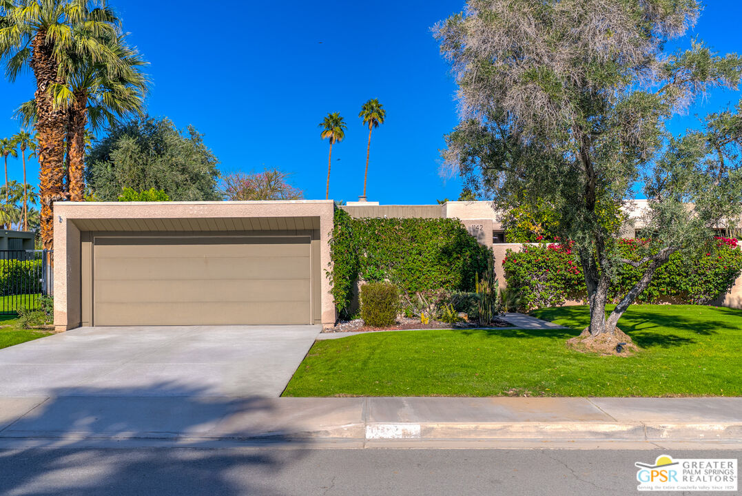 1142 East La Jolla Road Palm Springs, CA 92264 - Photo 2 of 35 a front view of a house with a yard and garage