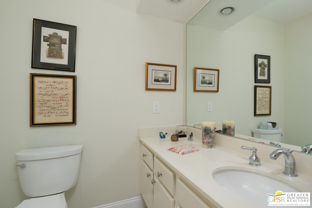 1142 East La Jolla Road Palm Springs, CA 92264 - Photo 25 of 35 a bathroom with a toilet sink and mirror