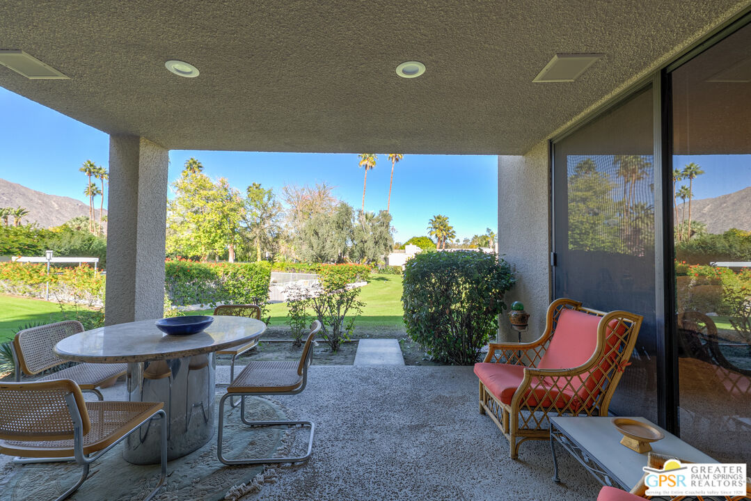 1142 East La Jolla Road Palm Springs, CA 92264 - Photo 27 of 35 a living room with furniture and a floor to ceiling window