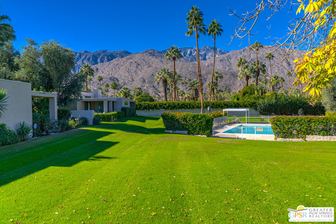1142 East La Jolla Road Palm Springs, CA 92264 - Photo 30 of 35 a view of a fountain in front of a house with a big yard