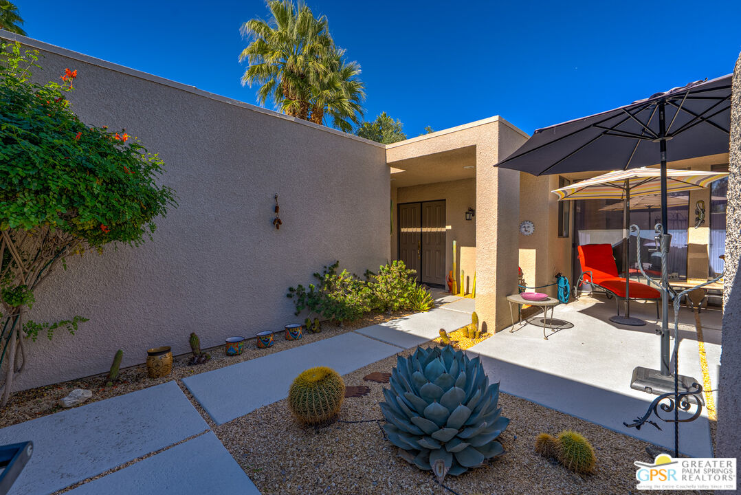 1142 East La Jolla Road Palm Springs, CA 92264 - Photo 3 of 35 a room with table and chairs potted plants