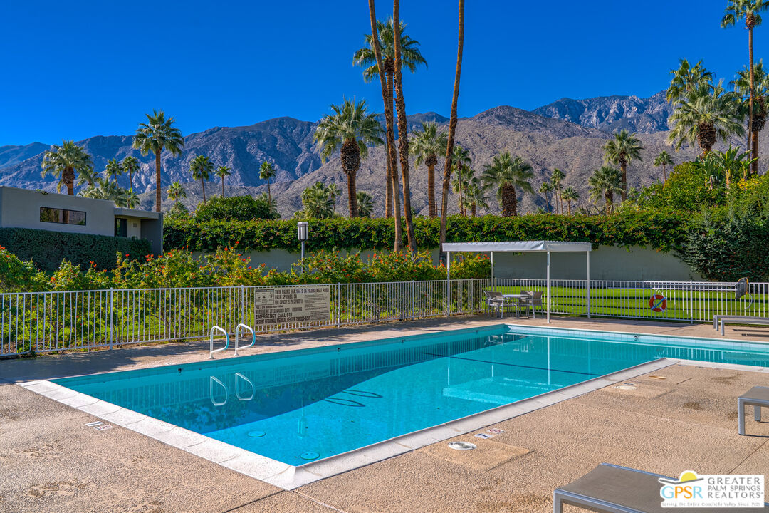 1142 East La Jolla Road Palm Springs, CA 92264 - Photo 32 of 35 a view of a swimming pool with a yard and a wooden deck