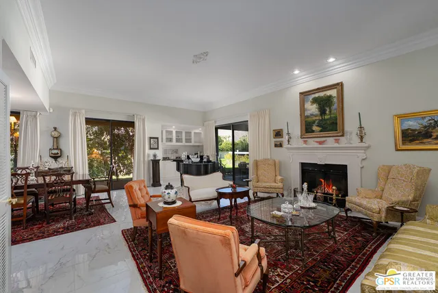 a living room with fireplace furniture and a flat screen tv