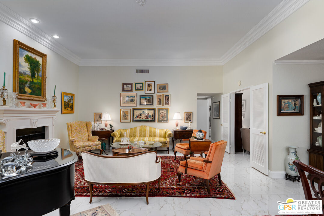1142 East La Jolla Road Palm Springs, CA 92264 - Photo 7 of 35 a living room with fireplace furniture and a flat screen tv