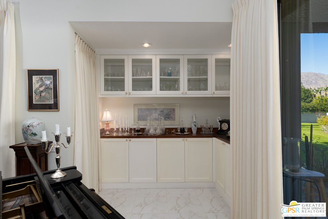 1142 East La Jolla Road Palm Springs, CA 92264 - Photo 8 of 35 a kitchen with a refrigerator and a stove