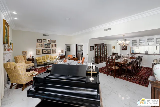 a living room with furniture kitchen view and a table