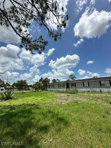 a view of a big yard with table and chairs