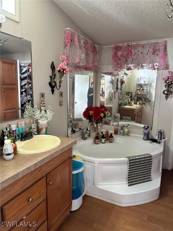 618 Hunting Club Avenue Clewiston, FL 33440 - Photo 27 of 32 a bathroom with a sink a mirror and a vase of flowers
