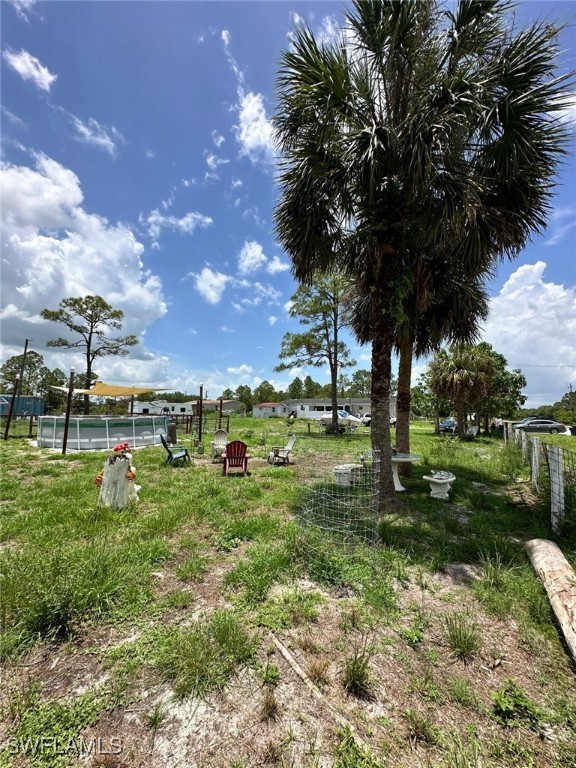 618 Hunting Club Avenue Clewiston, FL 33440 - Photo 29 of 32 a view of a garden with a tree