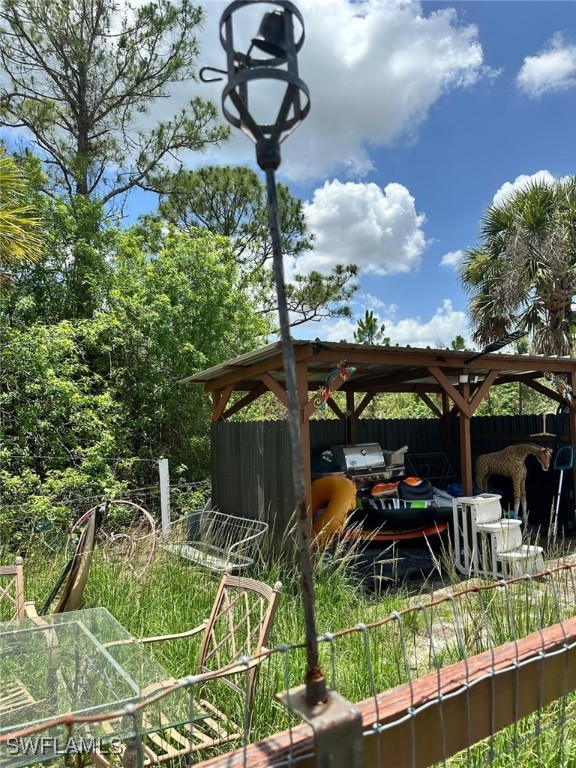 618 Hunting Club Avenue Clewiston, FL 33440 - Photo 31 of 32 a view of a porch with furniture and a yard
