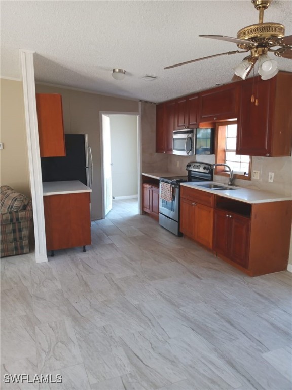 618 Hunting Club Avenue Clewiston, FL 33440 - Photo 4 of 32 a living room with stainless steel appliances kitchen island granite countertop a table chairs and a wooden cabinets