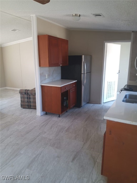 618 Hunting Club Avenue Clewiston, FL 33440 - Photo 5 of 32 a kitchen with stainless steel appliances granite countertop a stove a sink and a refrigerator