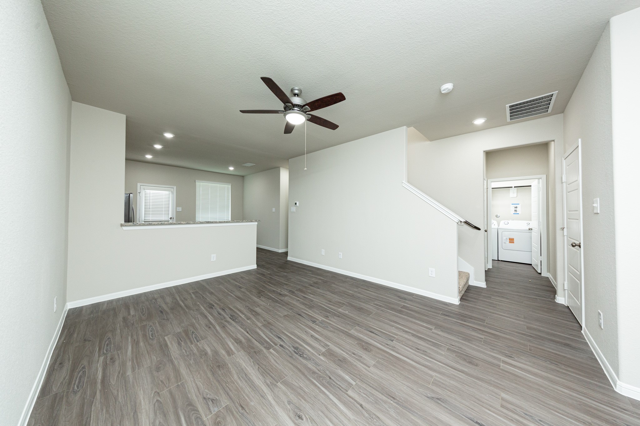 3058 Nickell Back Drive Conroe, TX 77301 - Photo 5 of 25 a view of an empty room with wooden floor and a ceiling fan