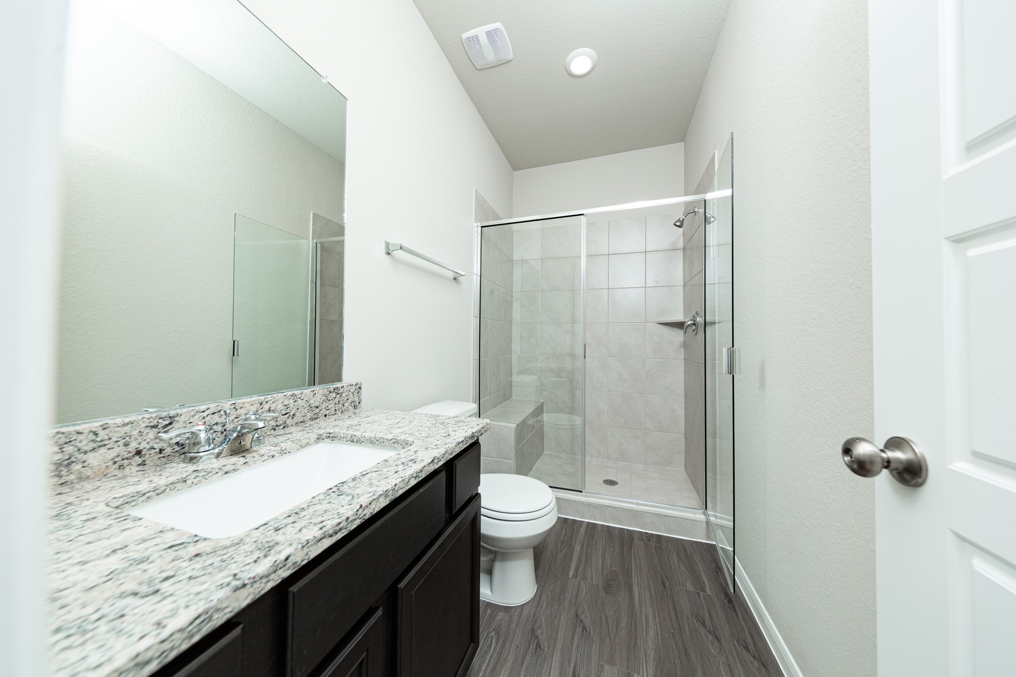 3058 Nickell Back Drive Conroe, TX 77301 - Photo 10 of 25 a bathroom with a granite countertop sink a toilet and shower
