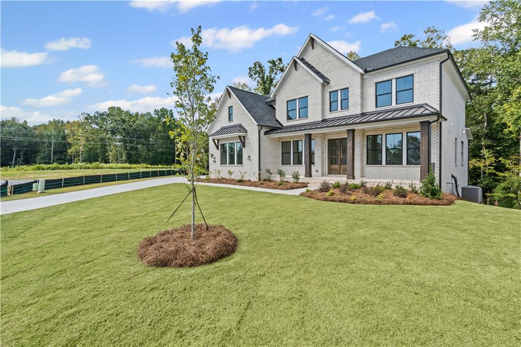 5115 Travers Lane Cumming, GA 30040 - Photo 2 of 32 a front view of a house with garden