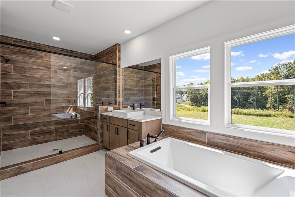 5115 Travers Lane Cumming, GA 30040 - Photo 23 of 32 a bathroom with a bathtub and a sink