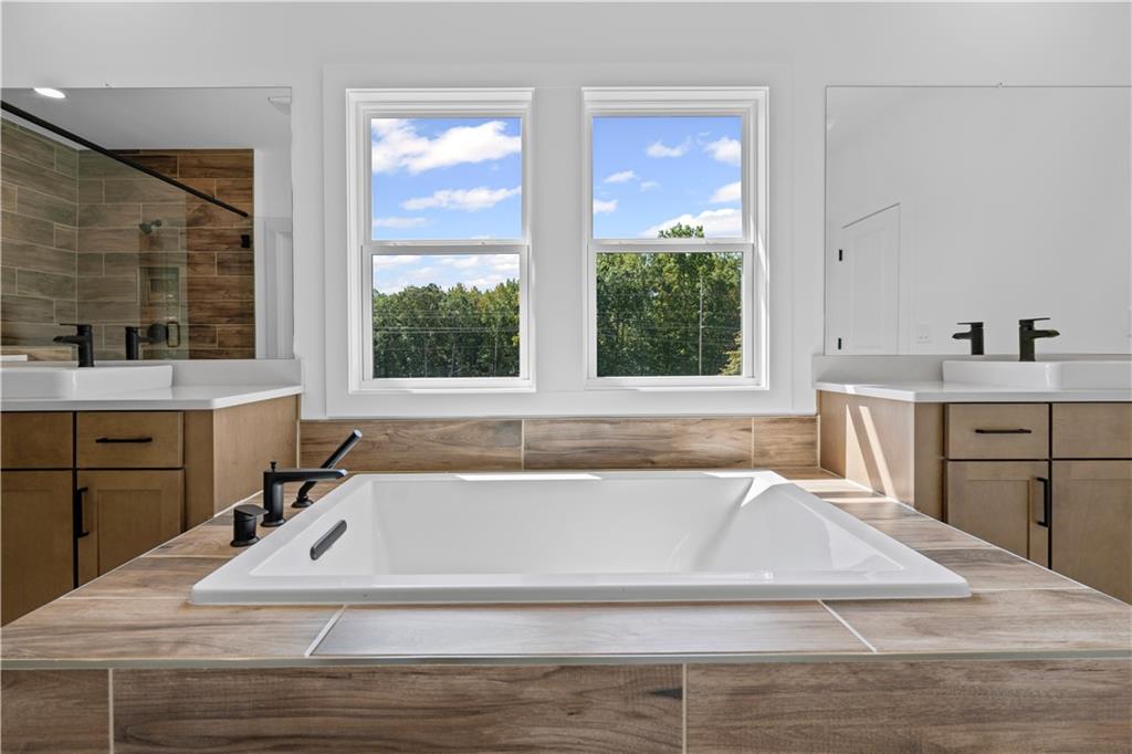 5115 Travers Lane Cumming, GA 30040 - Photo 25 of 32 a bathroom with a bathtub and a sink