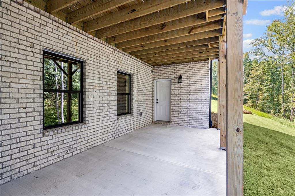 5115 Travers Lane Cumming, GA 30040 - Photo 29 of 32 a view of a porch with wooden floor and stairs