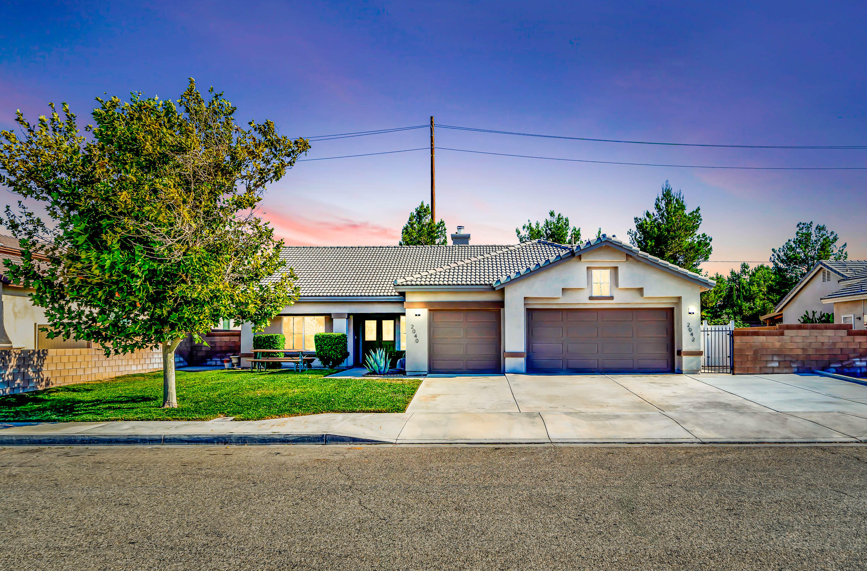 2040 West Avenue J7 Lancaster, CA 93536 - Photo 1 of 57 a view of a house with a yard and potted plants