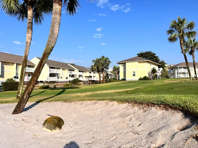 a view of a patio with table and chairs with wooden floor and fence