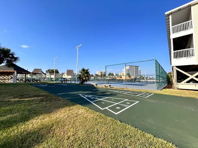 a view of a house with a balcony and yard