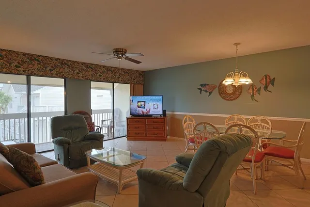 a living room with a couch and a chandelier