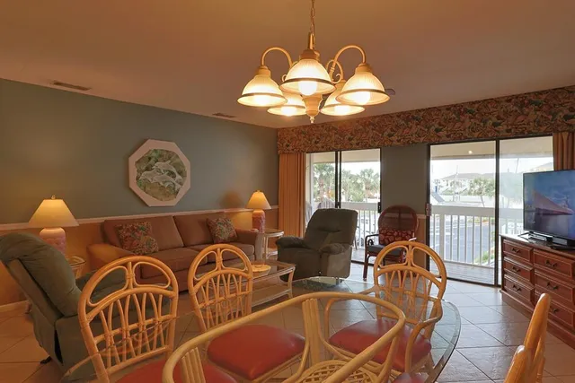 a view of a balcony with chairs and wooden floor