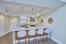 a kitchen with kitchen island granite countertop a kitchen island and chairs in it