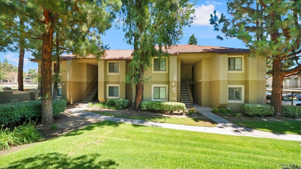 a view of a brick house with a yard