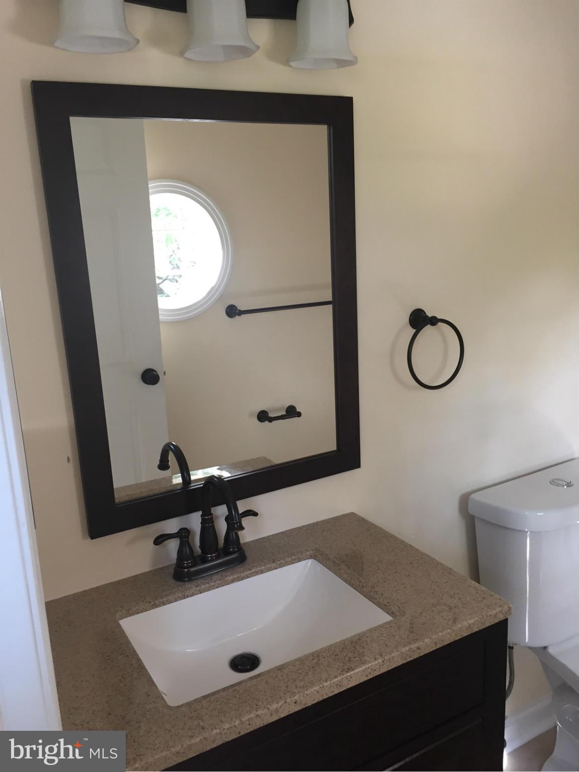 3623 Banquo Drive, Unit 62 Silver Spring, MD 20906 - Photo 5 of 5 a bathroom with a sink vanity and mirror