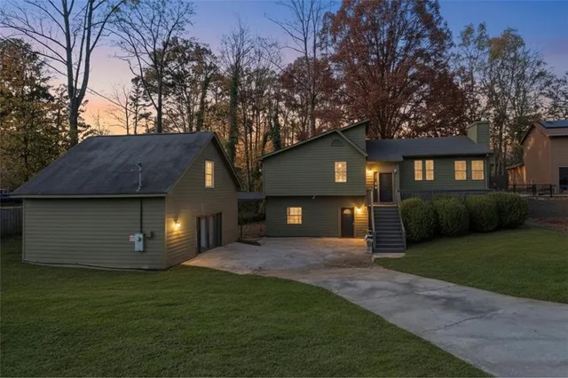 a front view of a house with a garden and yard