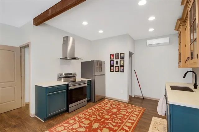a kitchen with stainless steel appliances granite countertop a sink stove and refrigerator