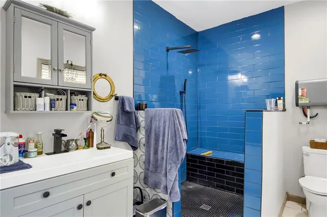 a bathroom with a sink a toilet and shower