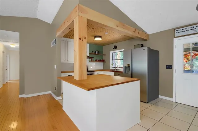 a kitchen with stainless steel appliances granite countertop a sink and a refrigerator