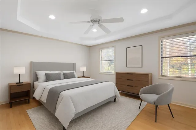 a bedroom with a bed a chair and a chandelier