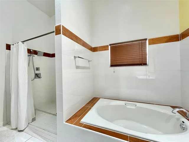 a bathroom with a tub and shower