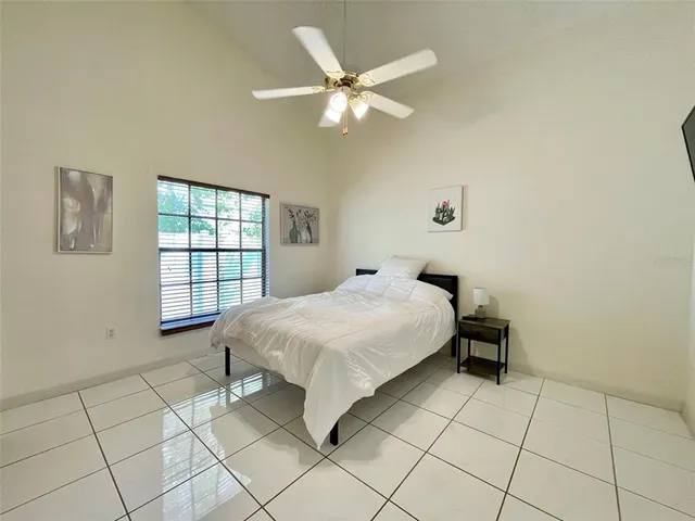 a bedroom with a bed and a window