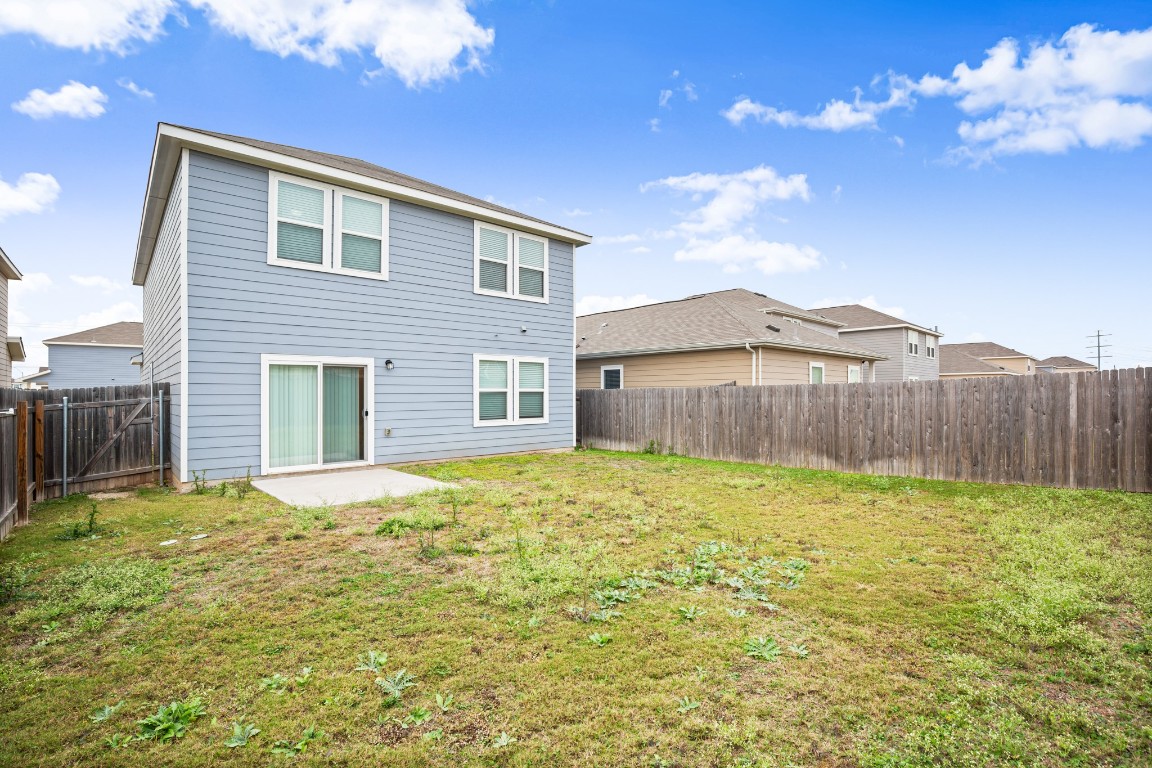 109 Gray Fox Loop Hutto, TX 78634 - Photo 20 of 28 Rear view of house featuring a patio and a fenced backyard