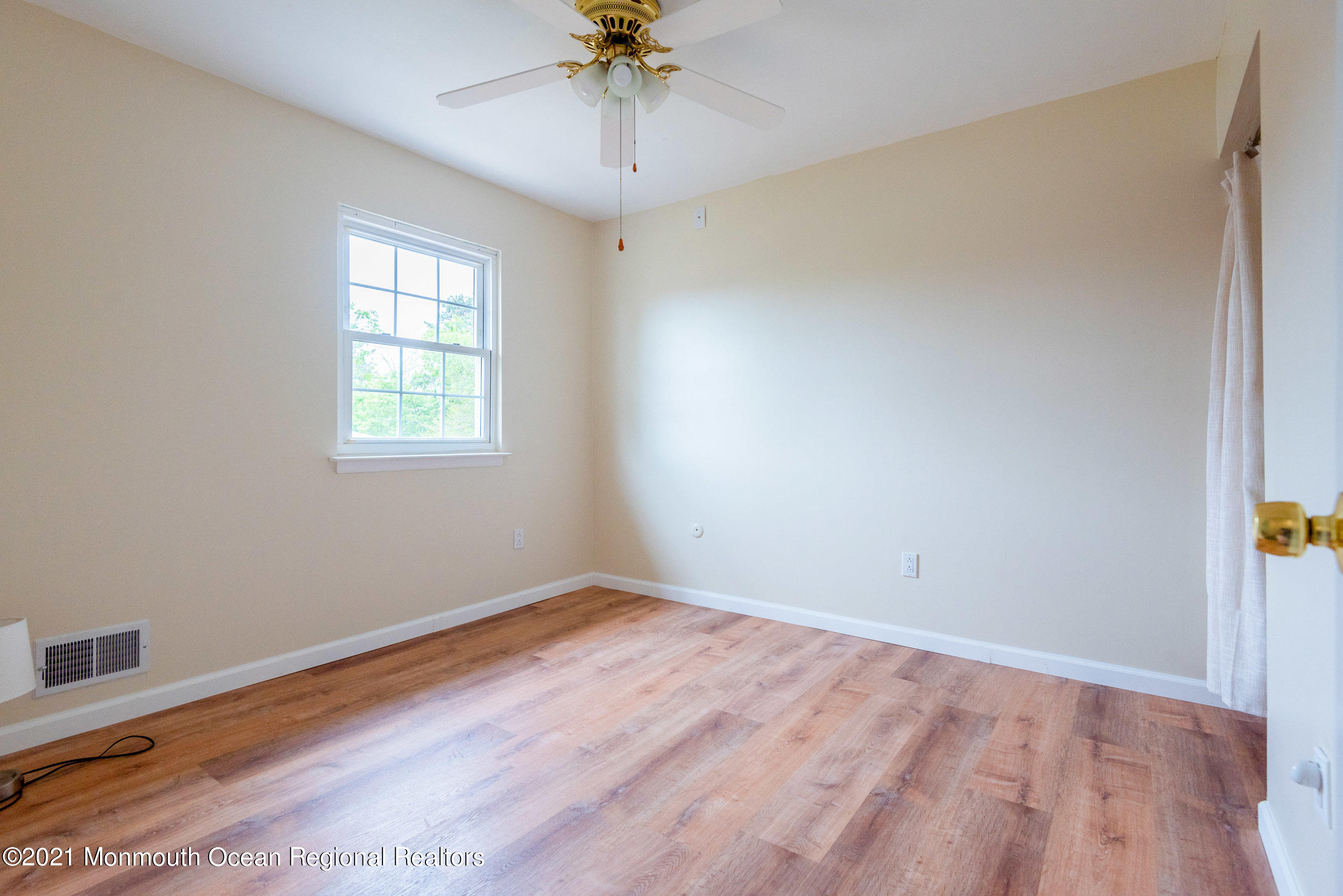 48 Greenwood Loop Road Brick, NJ 08724 - Photo 14 of 20 wooden floor in an empty room with a window