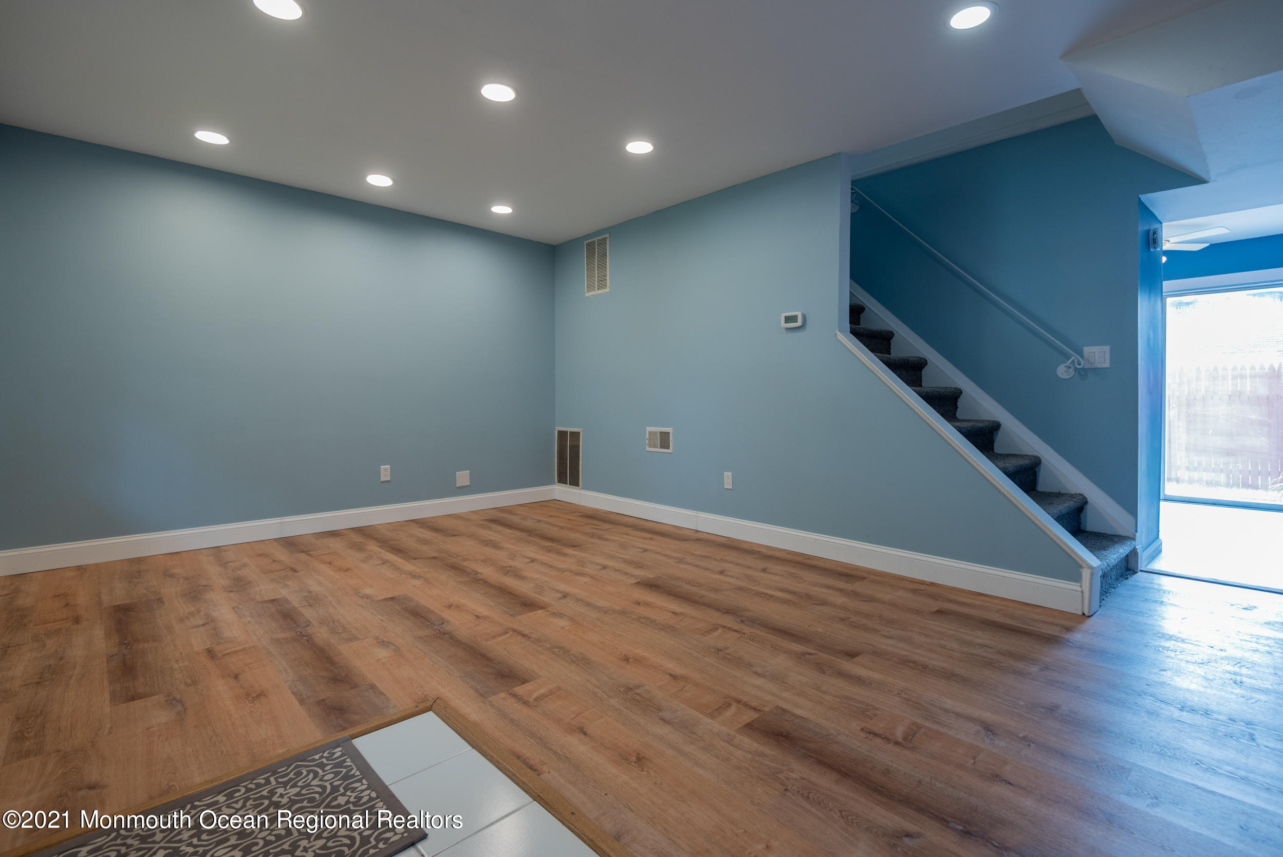 48 Greenwood Loop Road Brick, NJ 08724 - Photo 3 of 20 an empty room with wooden floor and staircase