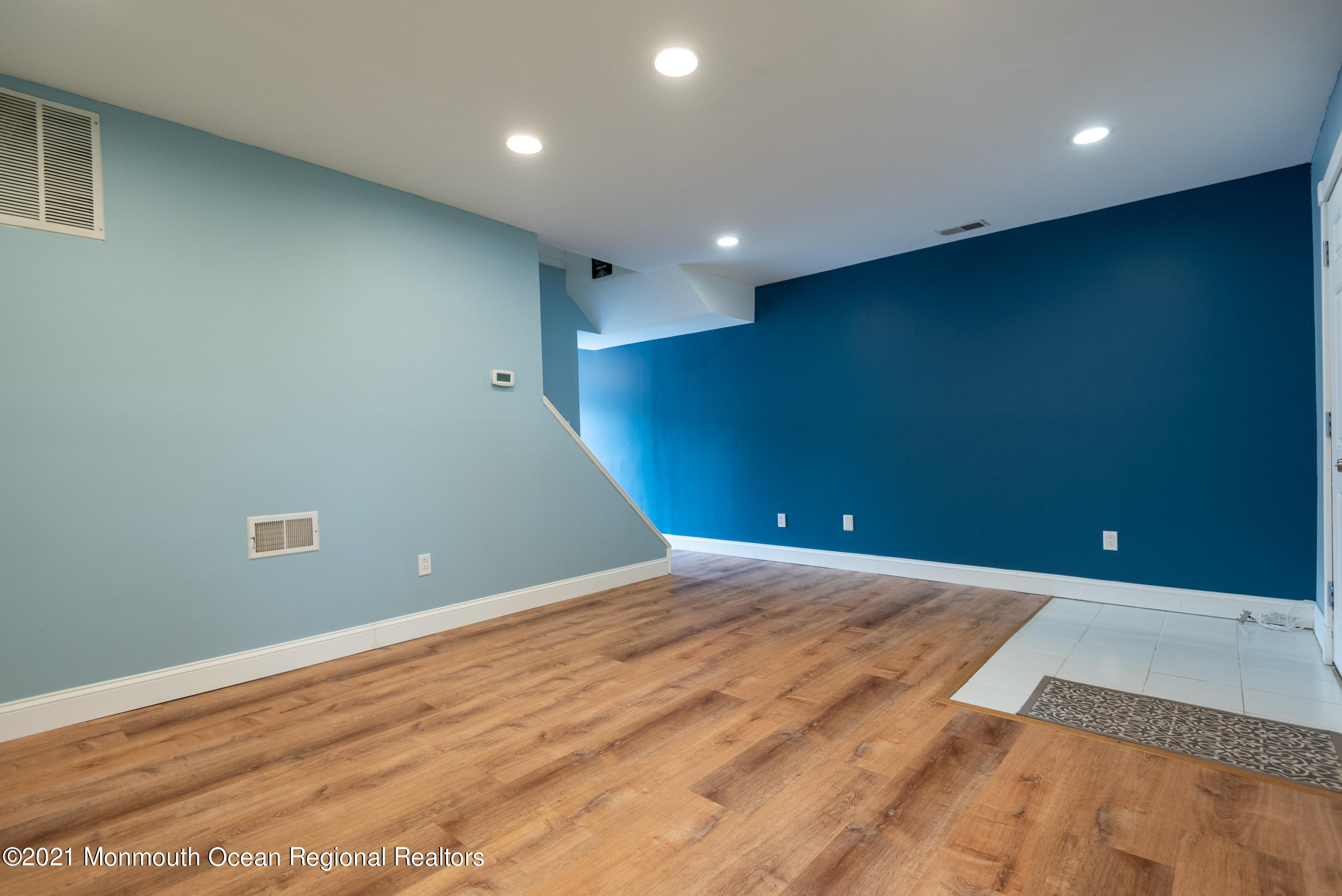 48 Greenwood Loop Road Brick, NJ 08724 - Photo 4 of 20 an empty room with wooden floor and windows