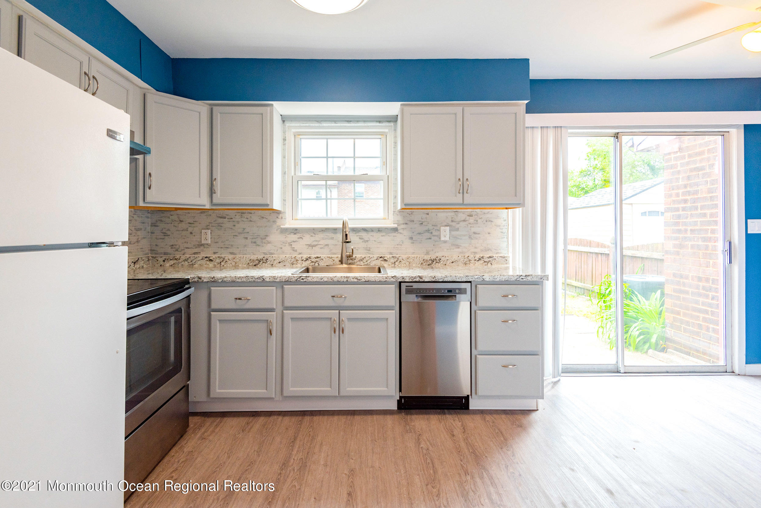 48 Greenwood Loop Road Brick, NJ 08724 - Photo 9 of 20 a kitchen with granite countertop white cabinets and white appliances