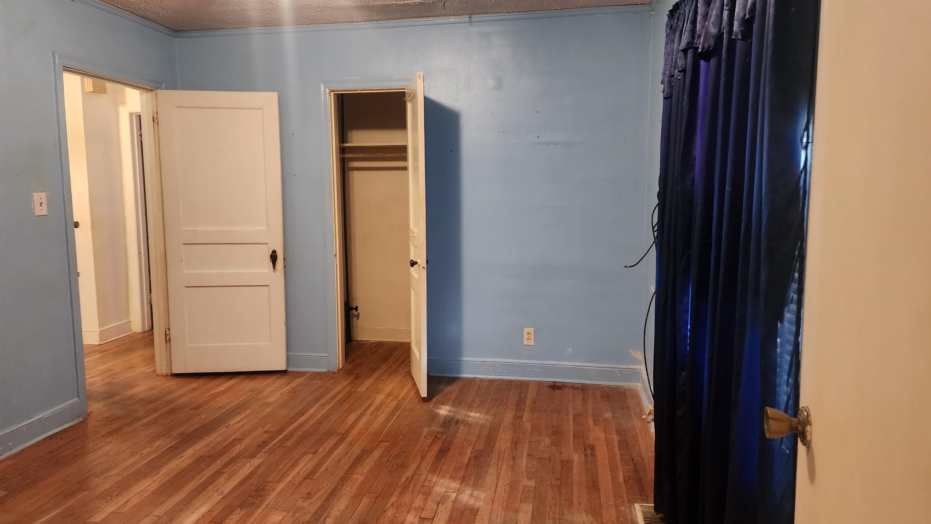1069 McEvers Road Memphis, TN 38111 - Photo 12 of 12 an empty room with wooden floor and closet