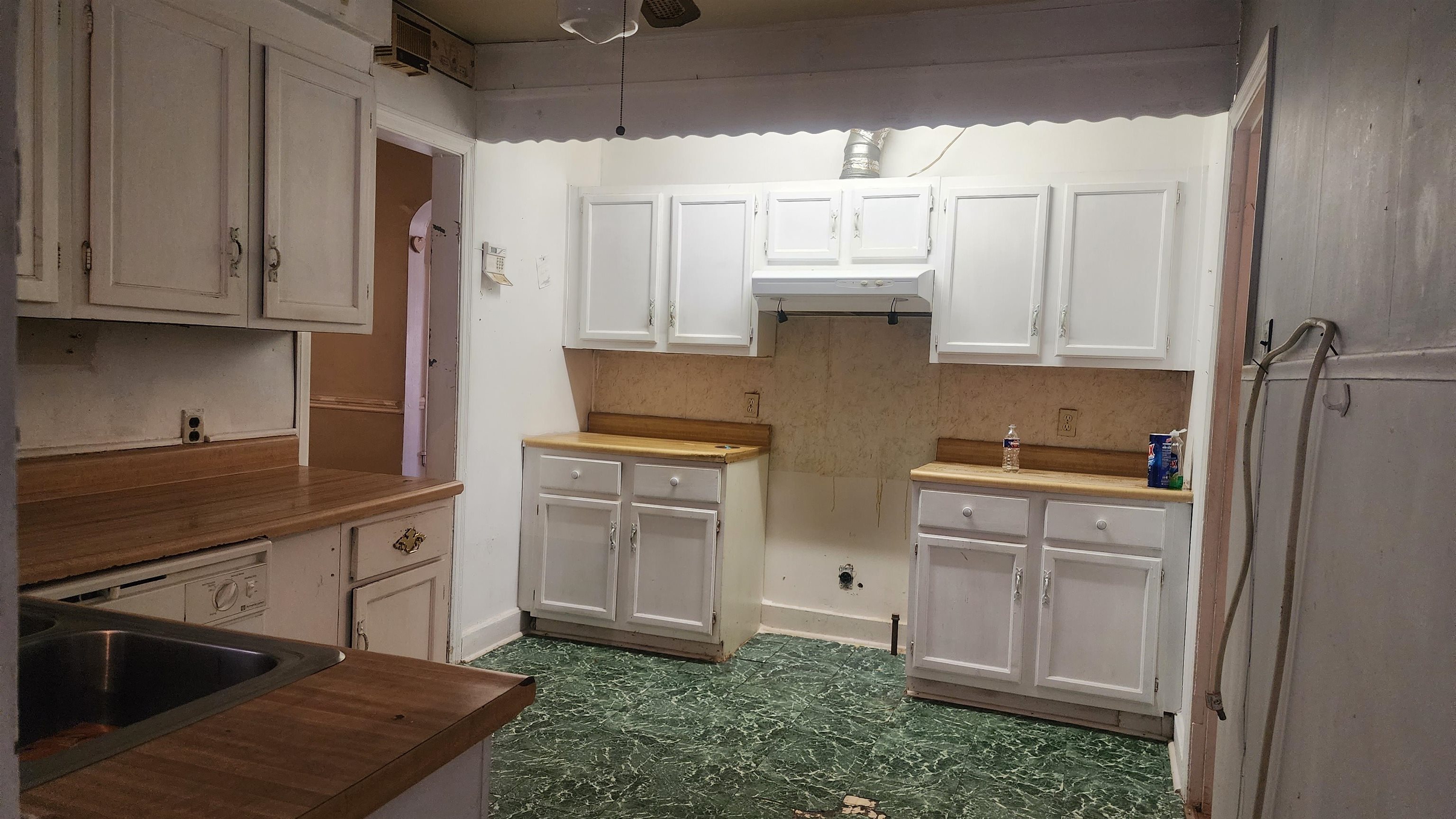 1069 McEvers Road Memphis, TN 38111 - Photo 2 of 12 a kitchen with white cabinets and white appliances