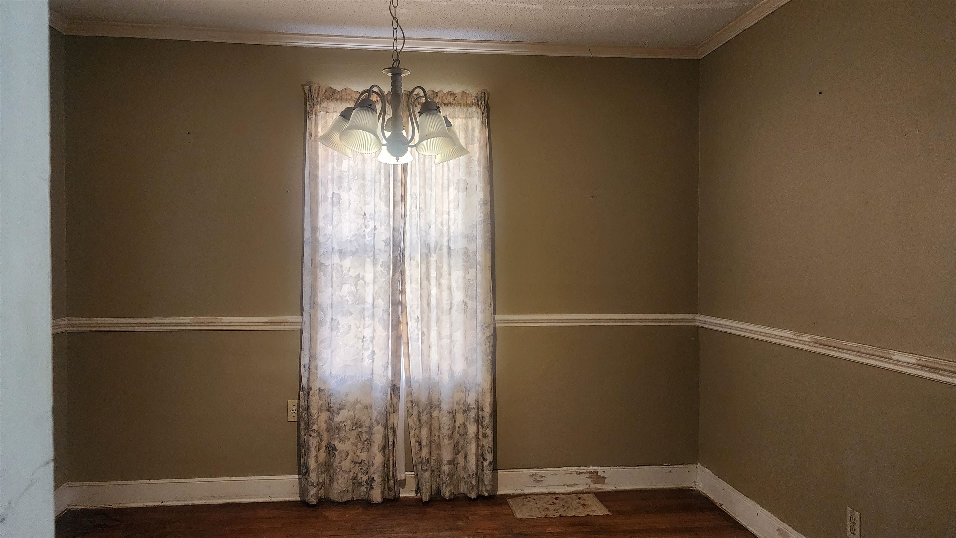 1069 McEvers Road Memphis, TN 38111 - Photo 9 of 12 a view of an empty room with wooden floor and a window