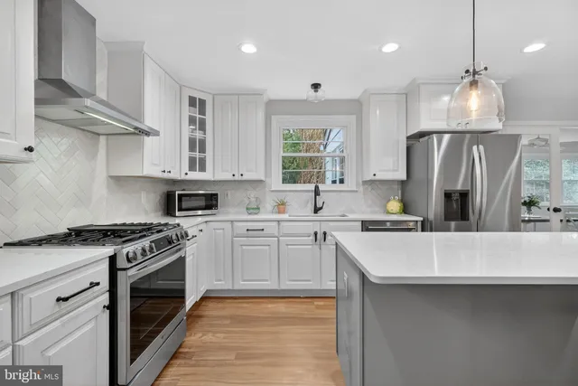 a kitchen with stainless steel appliances a sink stove and refrigerator