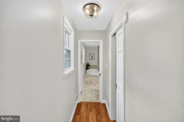 a spacious bedroom with a bed and a window