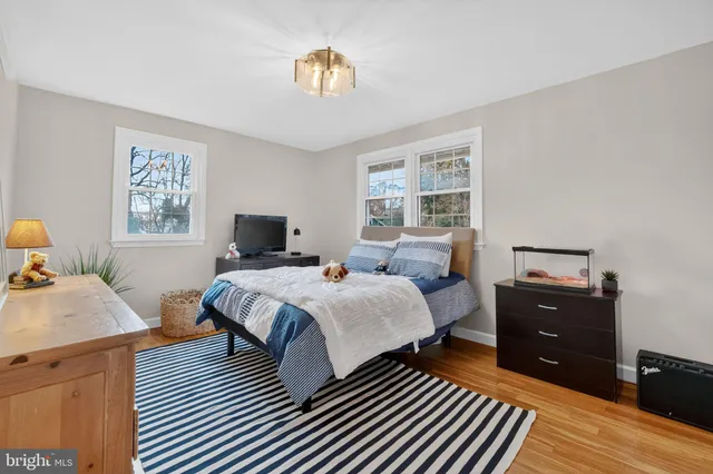 a bedroom with a bed and a chair