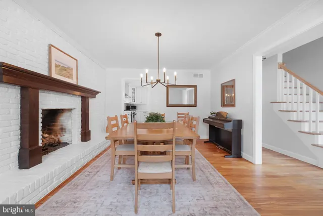 a living room with furniture a fireplace and a chandelier